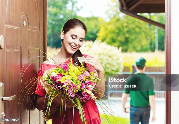 Happy Young Woman Receiving Flowers Stock Photo - Download Image Now - Delivery Person, Delivering, Gift