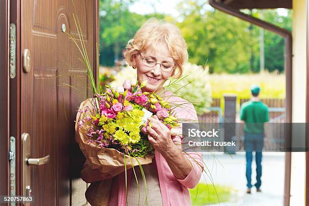 Happy Senior Woman Receiving Flowers Stock Photo - Download Image Now - Delivering, Gift, Senior Women