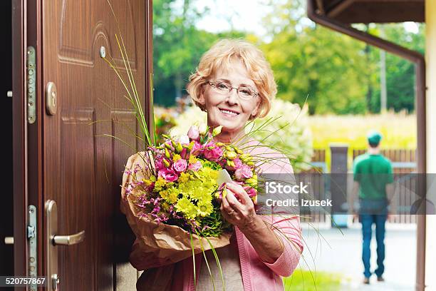 Happy Senior Woman Receiving Flowers Stock Photo - Download Image Now - Delivering, Senior Adult, 60-64 Years