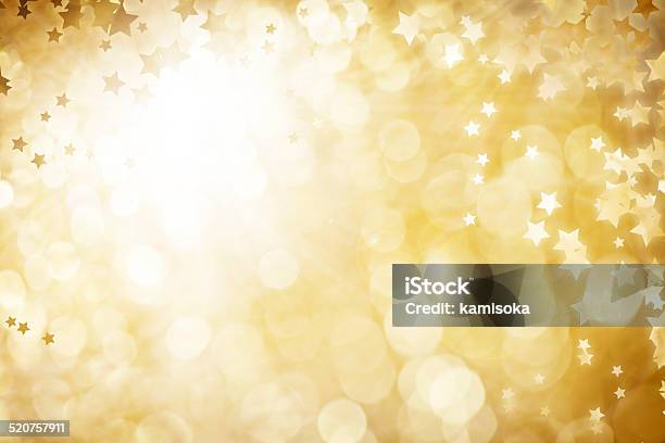 Gold Defocused Light Background For Christmas With Stars Stock Photo - Download Image Now