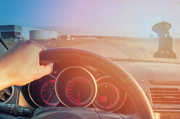 istock Driver's hands on steering wheel inside of a car 520765448