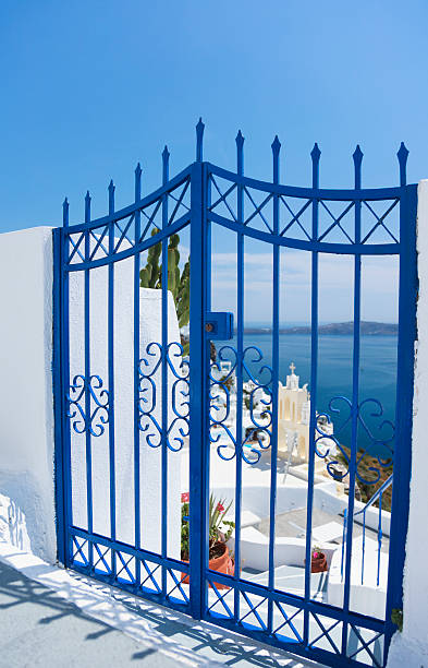 blue gate on santorini island (cyclades islands, greece) - santorini door sea gate bildbanksfoton och bilder