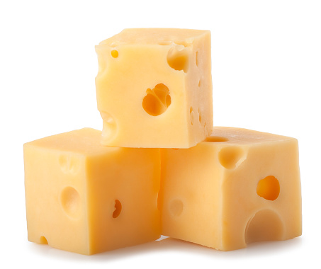 three cubes of cheese with big holes isolated on white background. Heap of maasdam pieces