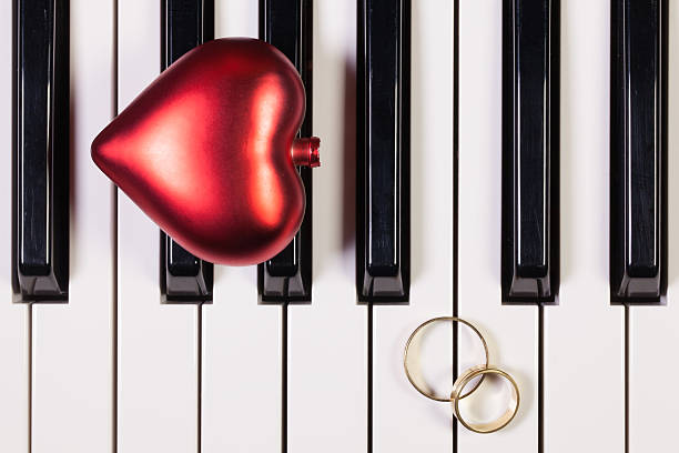 istock Piano keyboard,red heart and wedding rings 520770172