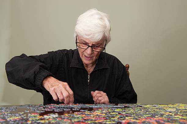 istock Jigsaw puzzle put together by an eldery woman 520770279