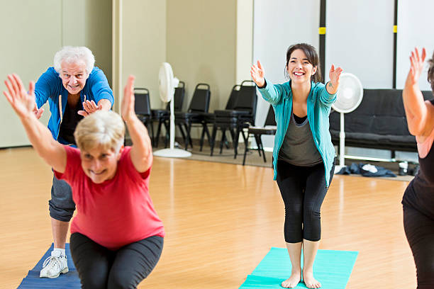 istock Yoga class demonstrates chair pose 520770542
