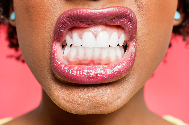 Portrait of an African American woman Cropped image of woman clenching teeth clenching teeth stock pictures, royalty-free photos & images