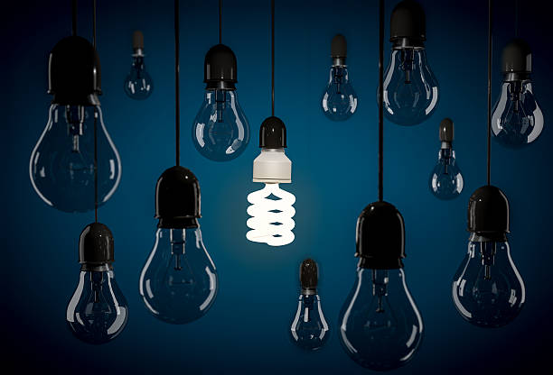 istock Eco energy saving bulb hanging on wire among incandescent bulb 520770898