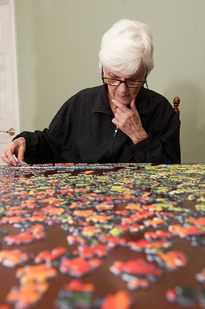 istock Jigsaw puzzle put together by an eldery woman 520771753