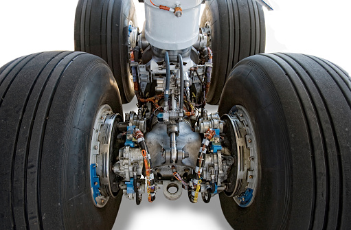 Landing gear close-up of commercial airplane isolated on white background.