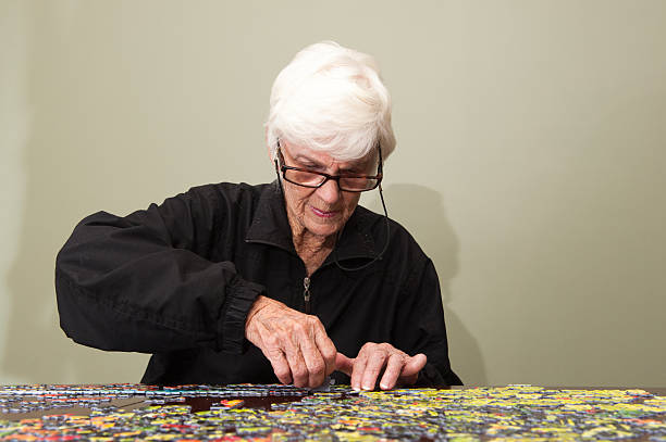 istock Jigsaw puzzle put together by an eldery woman 520771787
