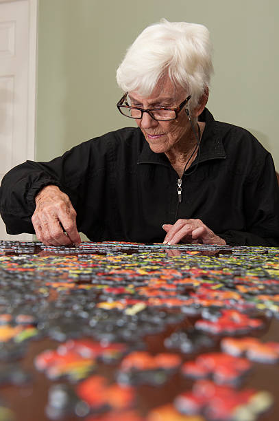 istock Jigsaw puzzle put together by an eldery woman 520771869
