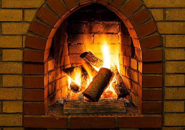 istock burning wooden logs in brick fireplace 520772082
