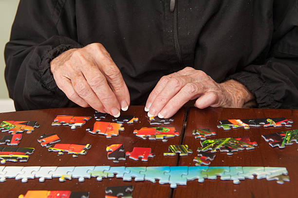 istock Jigsaw puzzle put together by an eldery woman 520772739