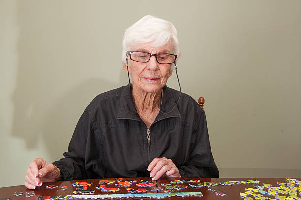 istock Jigsaw puzzle put together by an eldery woman 520772745