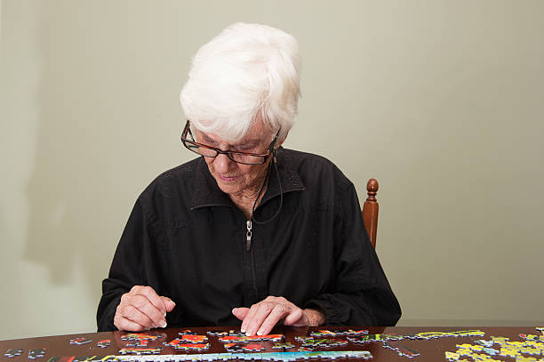 istock Jigsaw puzzle put together by an eldery woman 520772749