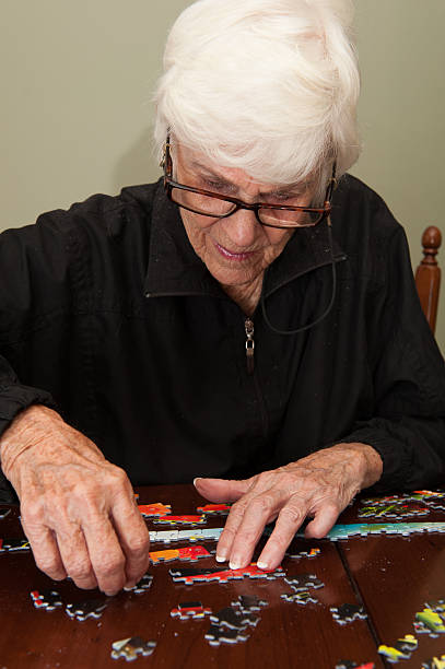 istock Jigsaw puzzle put together by an eldery woman 520772765