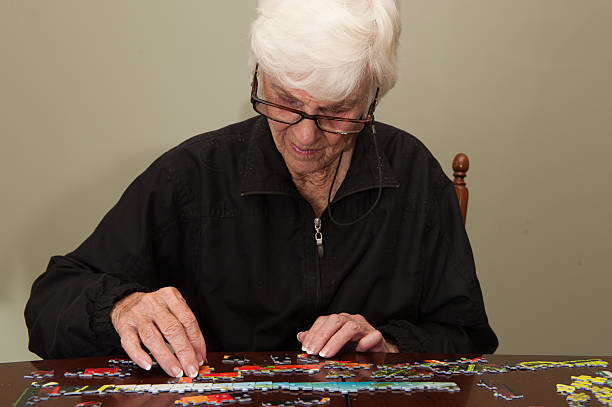 istock Jigsaw puzzle put together by an eldery woman 520772771