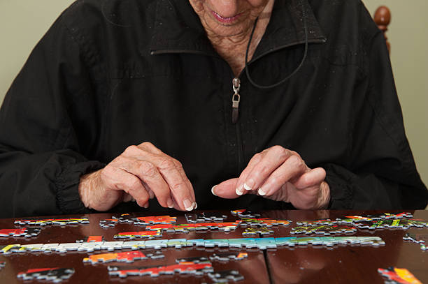 istock Jigsaw puzzle put together by an eldery woman 520772777