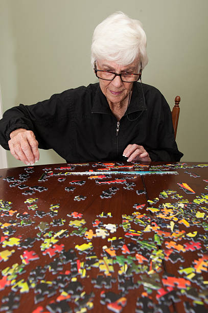 istock Jigsaw puzzle put together by an eldery woman 520772779