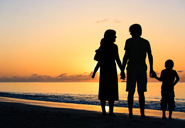 istock happy family with two kids on sunset beach 520772912