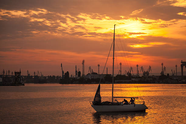 istock Yacht sails in Varna harbor at the sunset 520773691