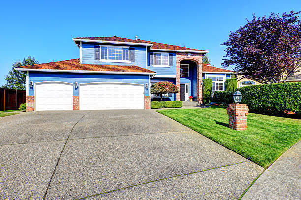 istock Light blue house exterior with brick trim and tile roof 520773777