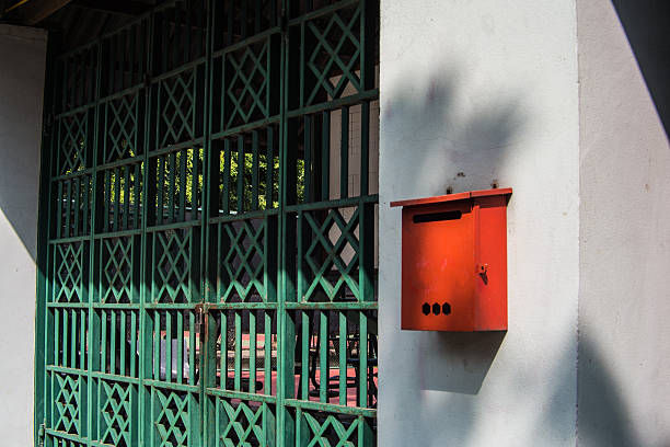 istock Red Mailbox and green steel door. 520774627