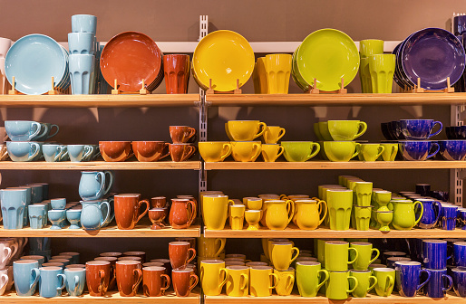 Store display of colorful tableware on the shelves.