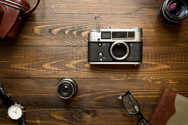 istock Top view of old analog camera, lenses, notebook and watches 520777244