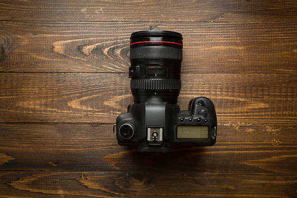 istock Professional digital camera on wooden background 520777634