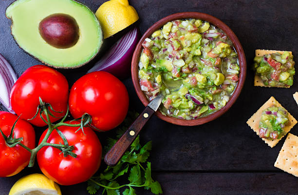 istock Guacamole latin american mexican sauce in clay bowl and ingredients 520778564