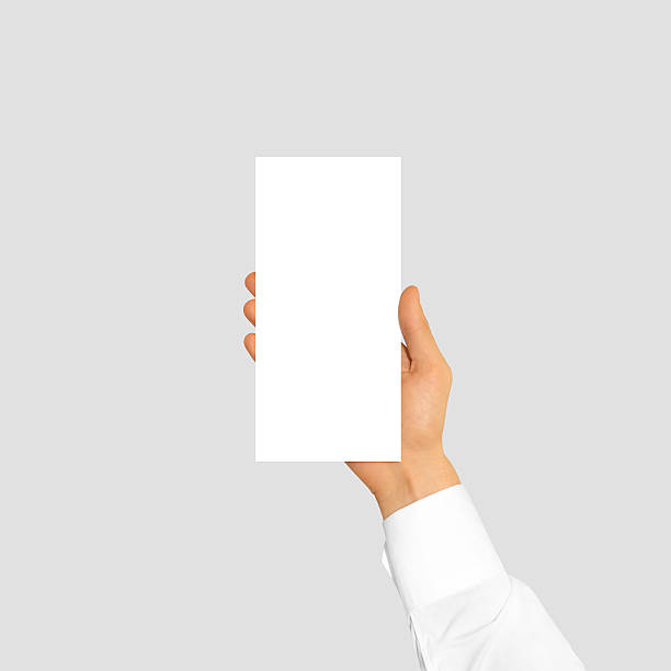 istock Hand holding blank flyer brochure booklet in the hand 520779030