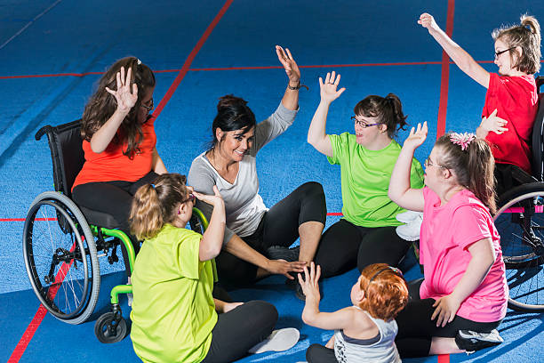 istock Group of special needs girls with instructor in gym 520779162