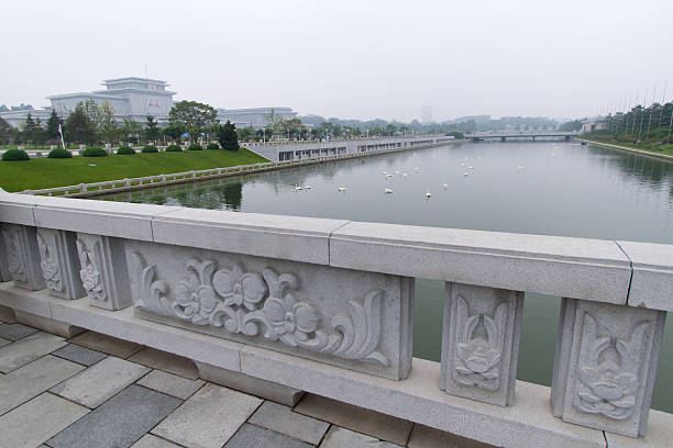 Bridge at Kumsusan Palace of the Sun (Kim Il-sung Mausoleum) Pyongyang, North Korea - Sep 07, 2014: Bridge leads across canal with swans to Kumsusan Palace of the Sun, the Memorial Palace also known as Kim Il-sung Mausoleum. kim il sung mausoleum stock pictures, royalty-free photos & images