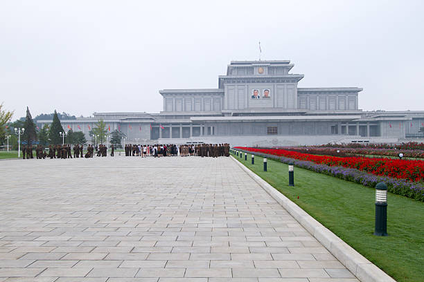 North Koreans & soldiers at Kumsusan Palace of the Sun Pyongyang, North Korea - Sep 07, 2014: North Korean citizens and soldiers gather in front of Kumsusan Palace of the Sun, the Memorial Palace also known as Kim Il-sung Mausoleum two days before the Founding Day of the DPRK. kim il sung mausoleum stock pictures, royalty-free photos & images