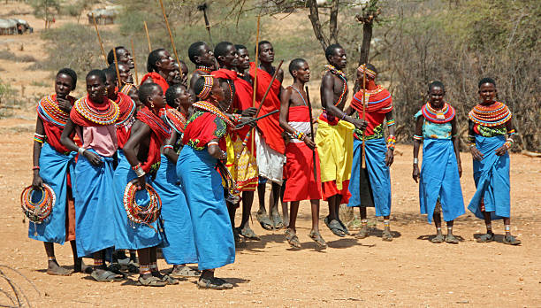 Masai territory, Kenya.  Masai people who wear traditional dress start the pogo dance to welcome visitors.