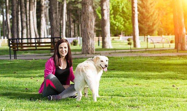 istock Young woman sitting with her dog 520780634