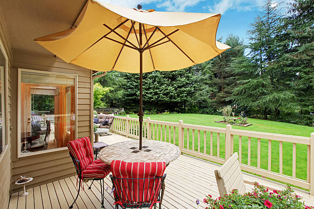 istock Patio table with yellow umbrella on walkout deck 520785963