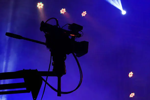 Videocamera silhouette on a concert stage