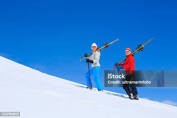Winter Sport Friends Men And Women Snow Skiers Carrying Skis Stock Photo - Download Image Now