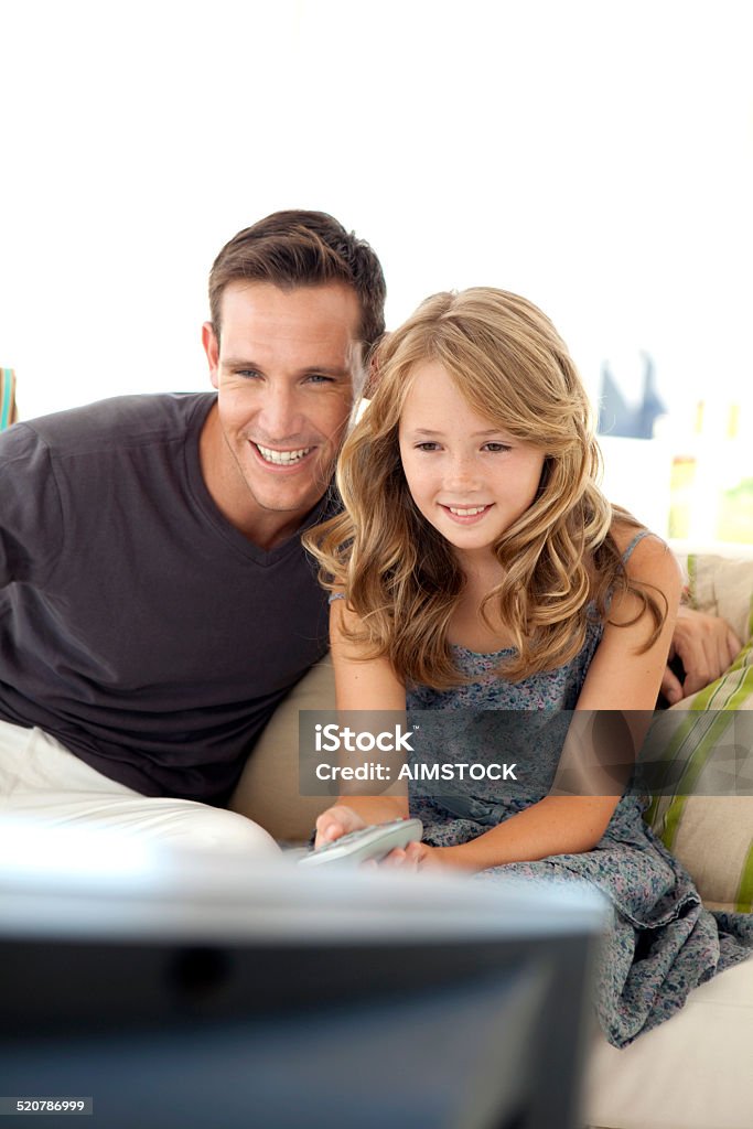 Watching TV with Dad Father and daughter watching TV together 30-39 Years Stock Photo