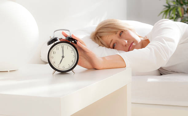 istock lady has woken up by an alarm clock. eyes open 520789067
