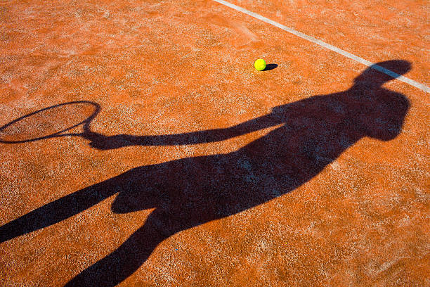 istock shadow of a tennis player in action 520789533