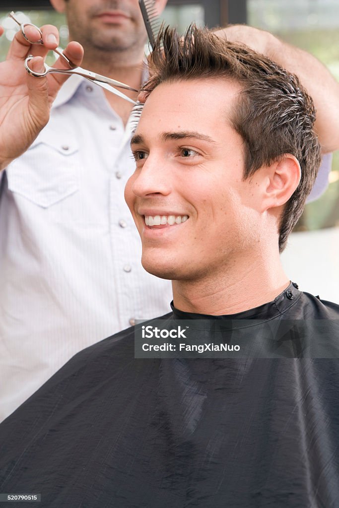 Man Getting Haircut at Salon 20-24 Years Stock Photo