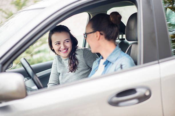 istock Three Young Women Driving in Car and Having Fun 520790681