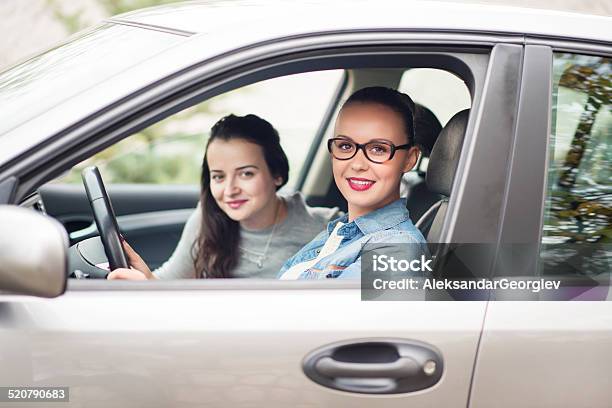 Two Young Women Driving In Car And Having Fun Stock Photo - Download Image Now - 20-29 Years, Adult, Adults Only