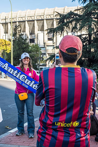 Barcelona supporter and his girlfriend, who supports Real Madrid stock photo