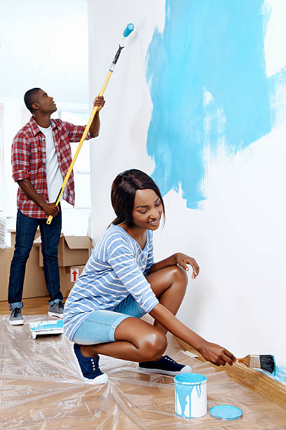 istock painting house couple 520792739