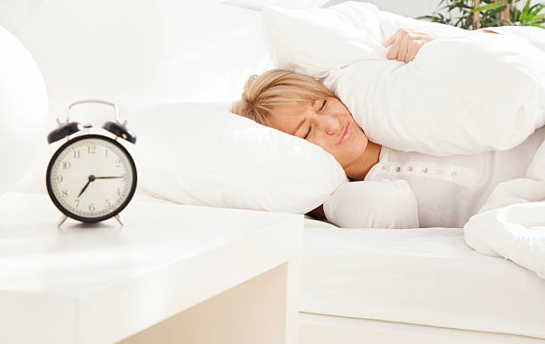 istock lady has woken up by an alarm clock eyes closed 520792947